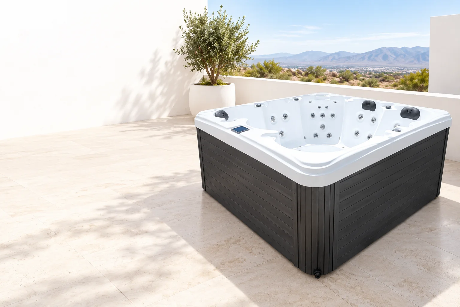 Ocean Spas hot tub with white shell and dark charcoal cabinet on a bright terrace